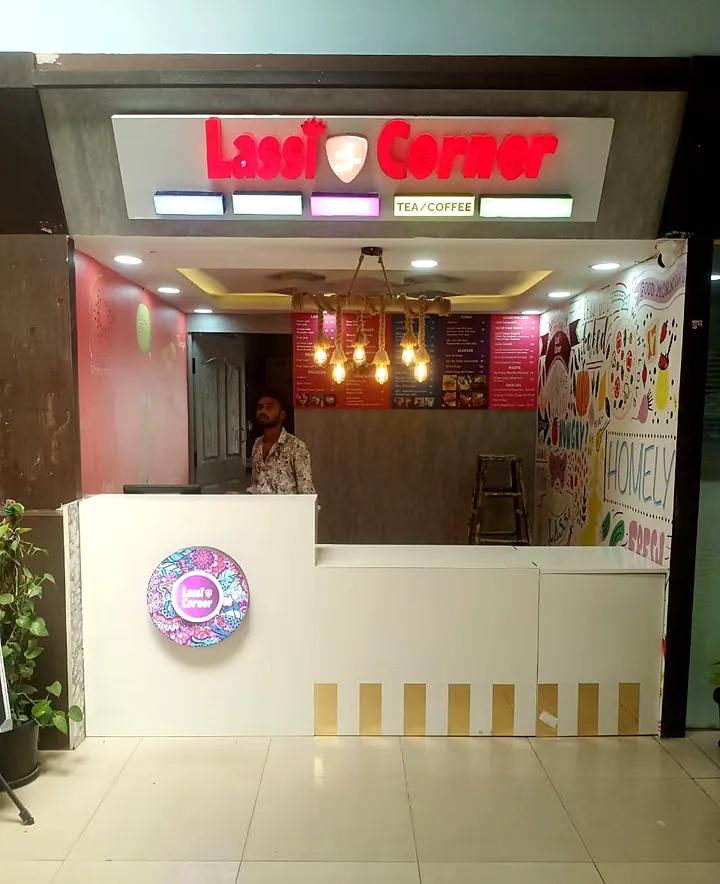 Lassi Corner counter kiosk with lit fascia and round glow logo